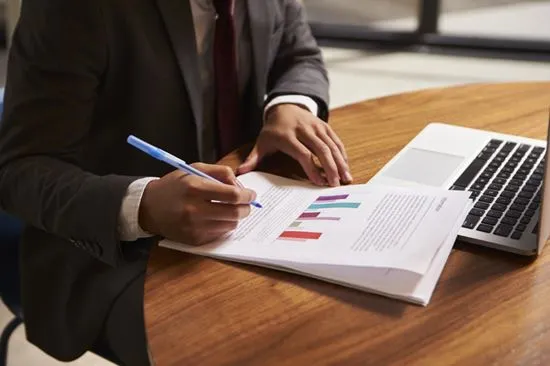 Businessman reviewing inspection documentation and graphs